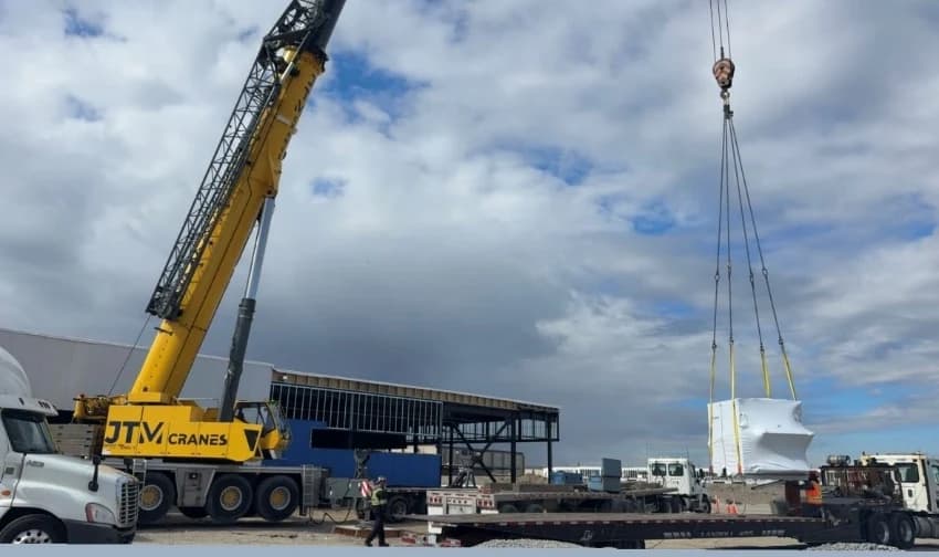 JTM Cranes all terrain crane and flatbed trailers loaded with precast concrete panels
